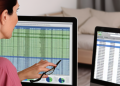 Woman looking at a computer screen showing spreadsheet of tracking results